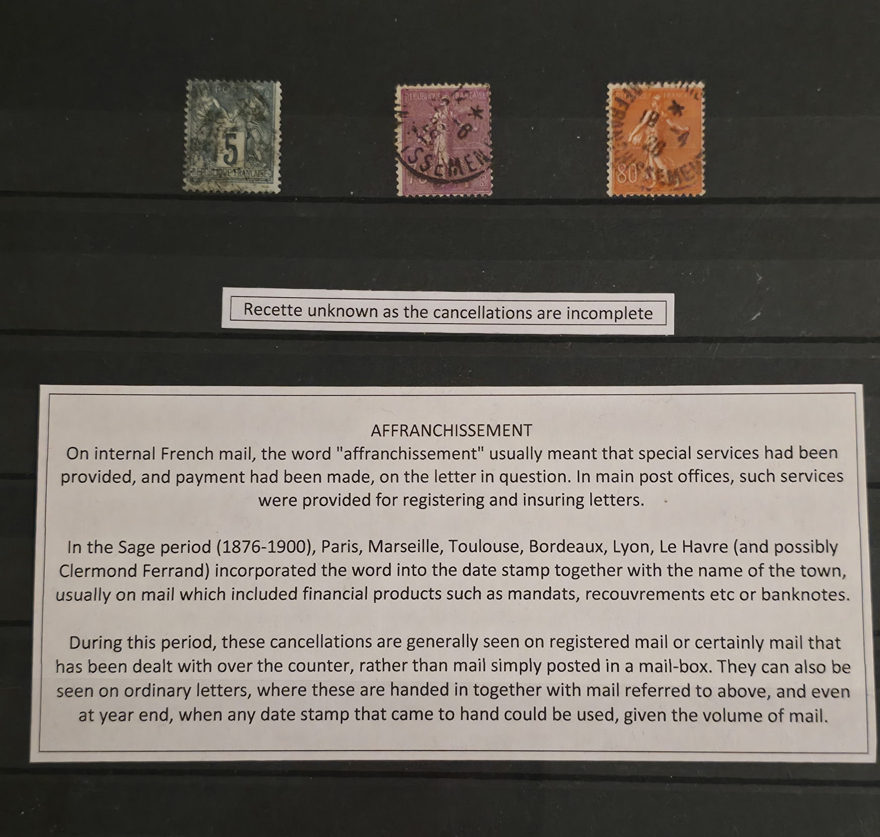 a group of postage stamps on a black board