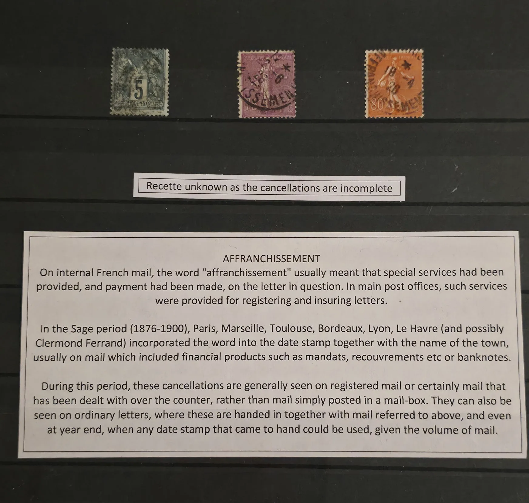 a group of postage stamps on a black board