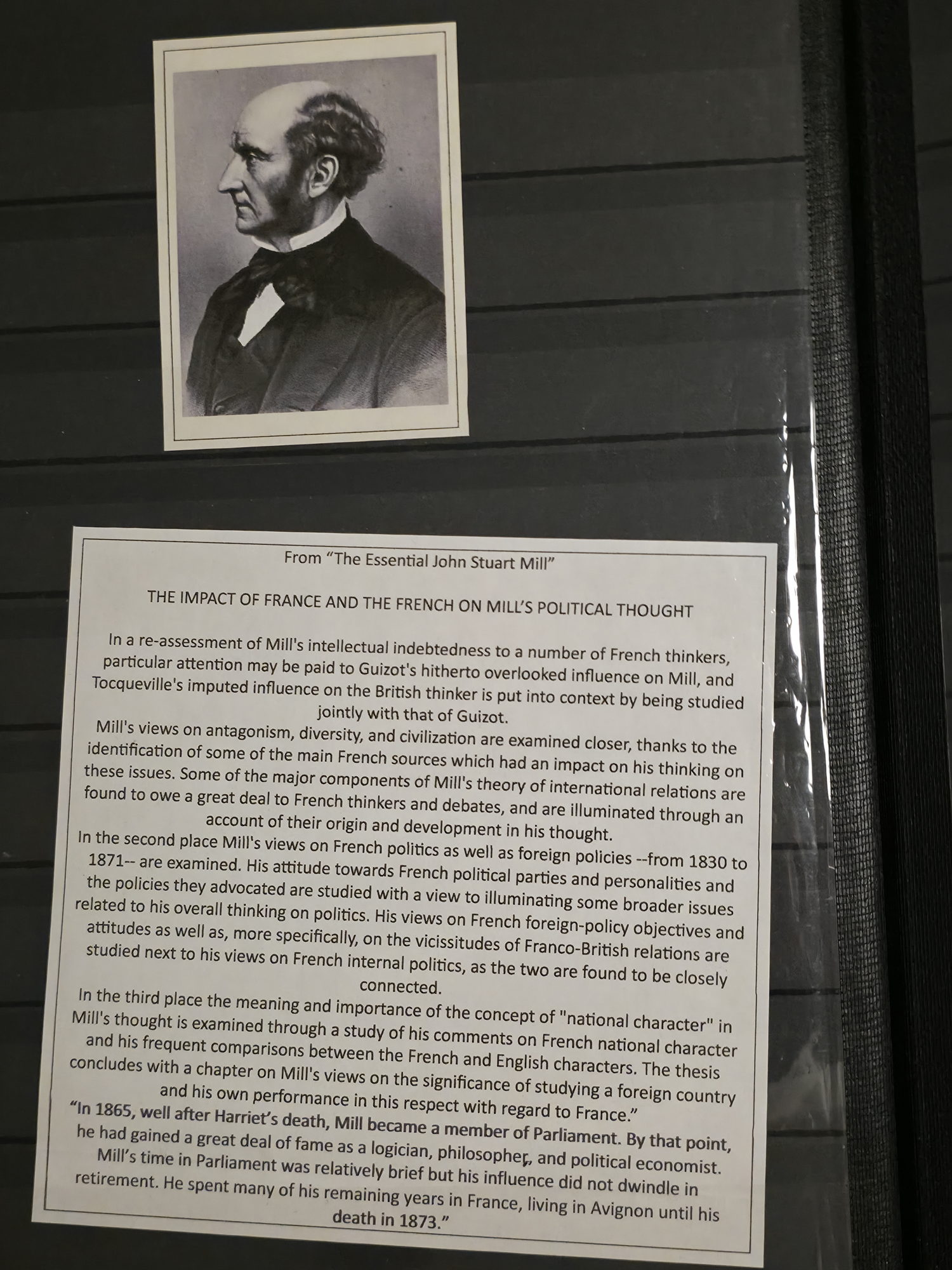 a paper and a picture on a wall