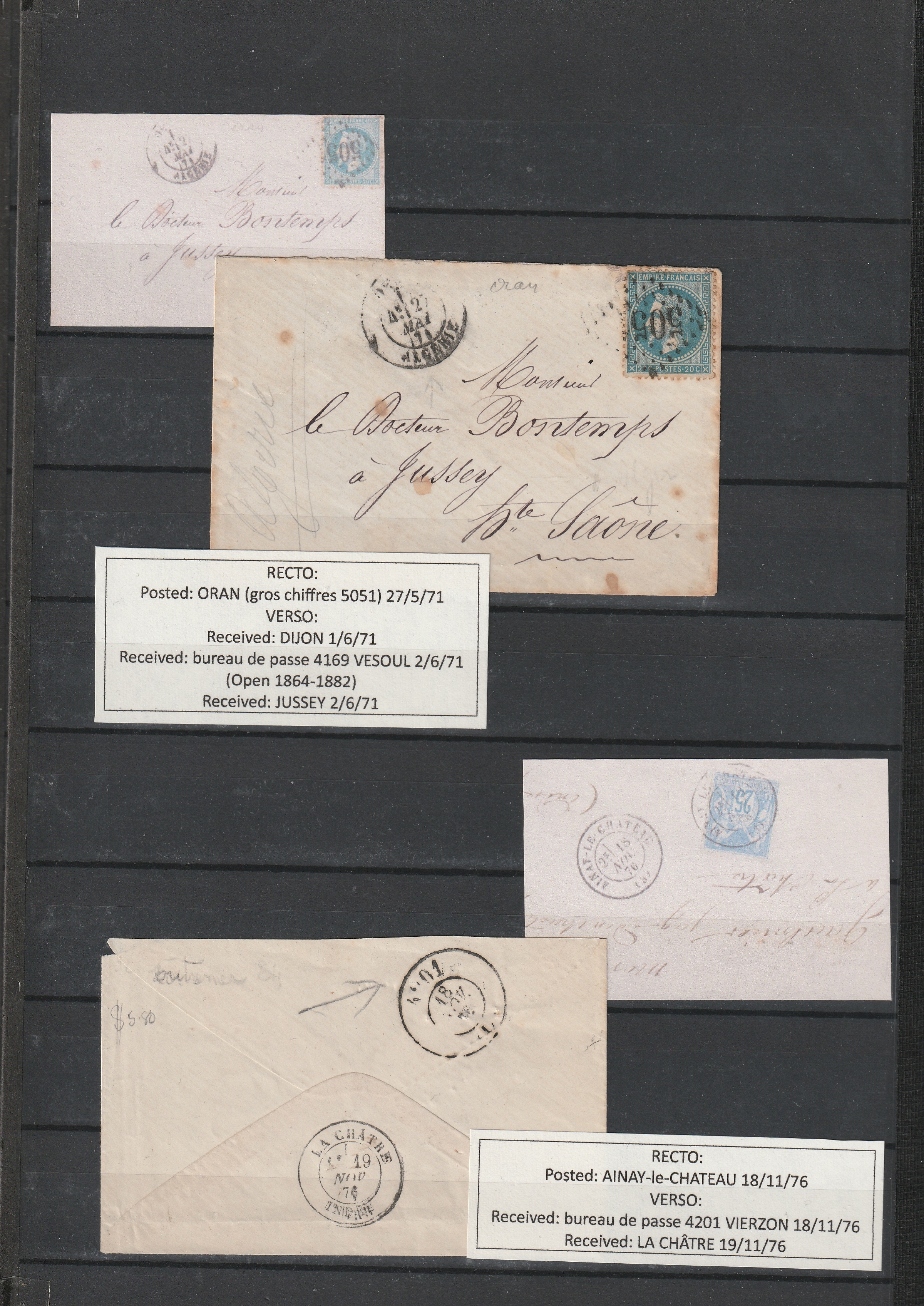 a group of envelopes on a black board