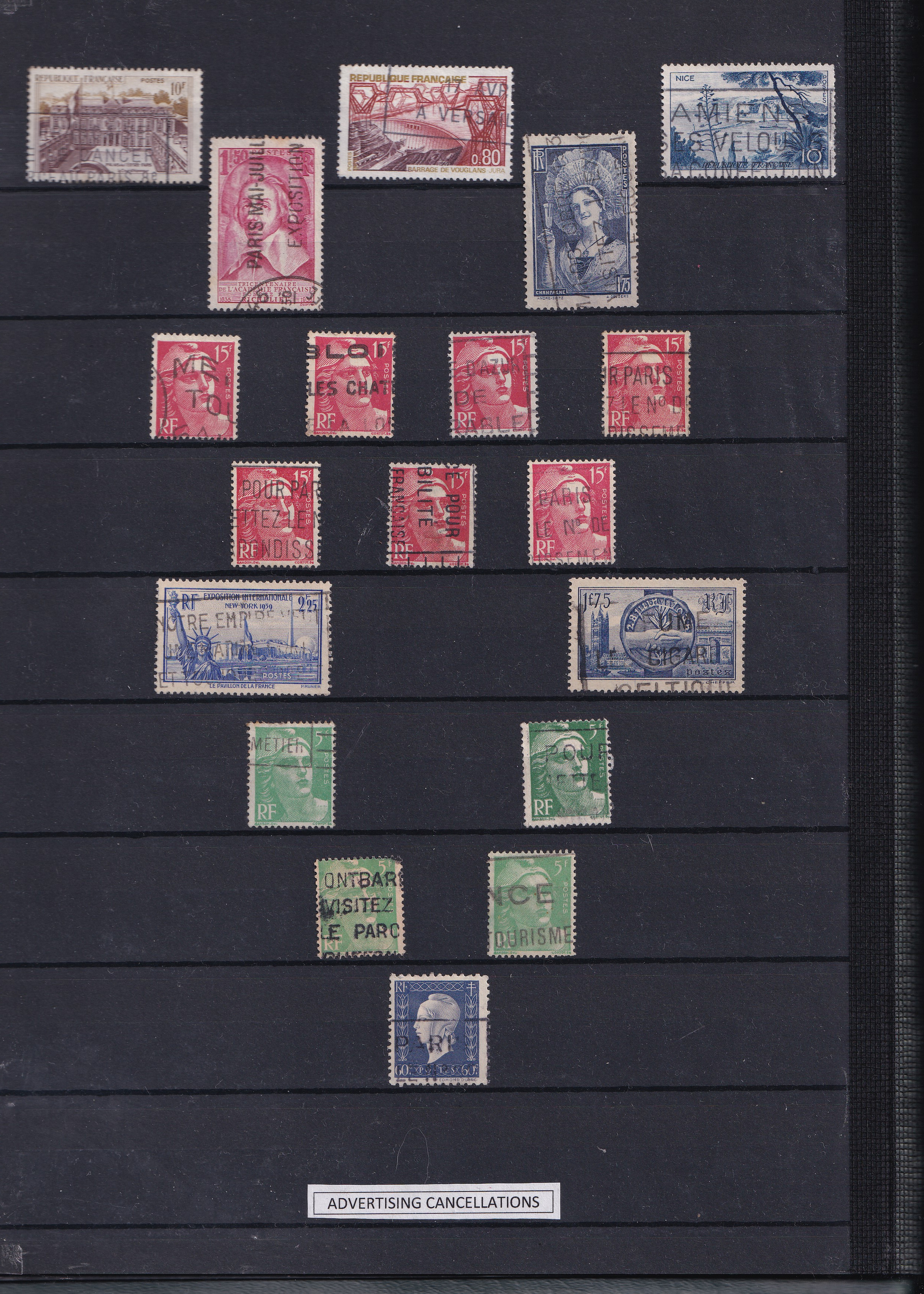 a group of postage stamps on a black surface